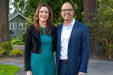 Hope and Sanjit Biswas pose in a suburban driveway