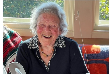 100-year-old Jeanne Shapiro Bamberger laughs with the unseen photographer