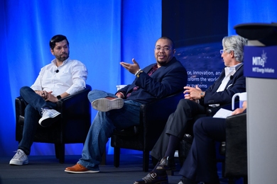 Three men have a conversation onstage