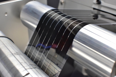 Photo of a flexible solar film being fabricated on a roll-to-roll printer