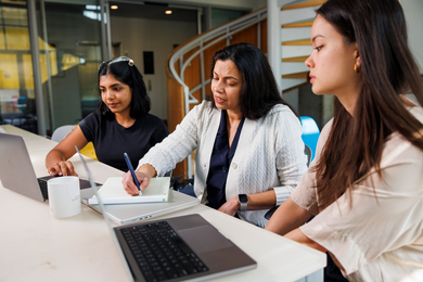 Irene Tenison, Lalana Kagal and Anna Murphy at desk with laptops