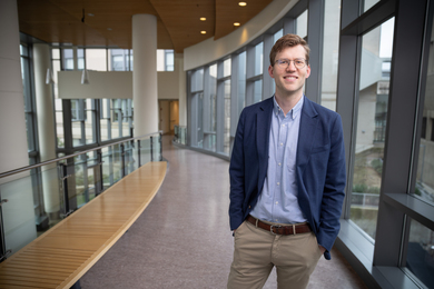 Emil Verner stands near windows in Sloan building 